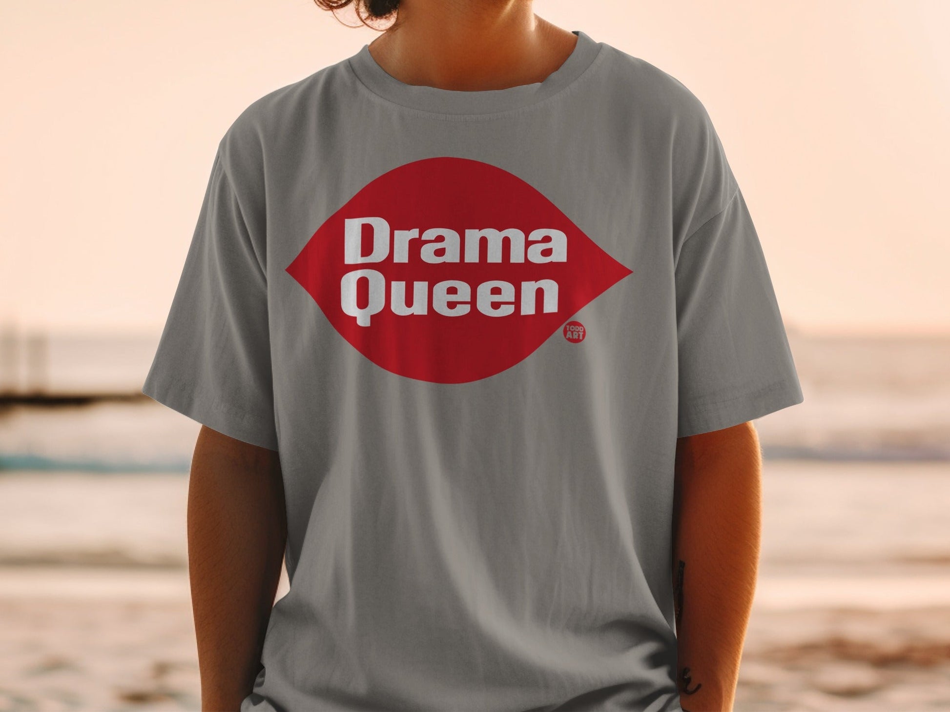Grey t-shirt with "Drama Queen" in red lettering on a white diamond.