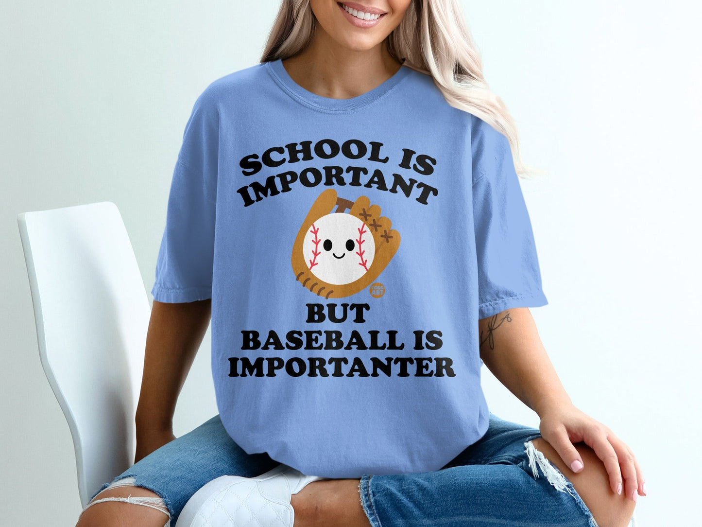 Light blue t-shirt with "School is Important But Baseball is Importanter" text and baseball graphic.