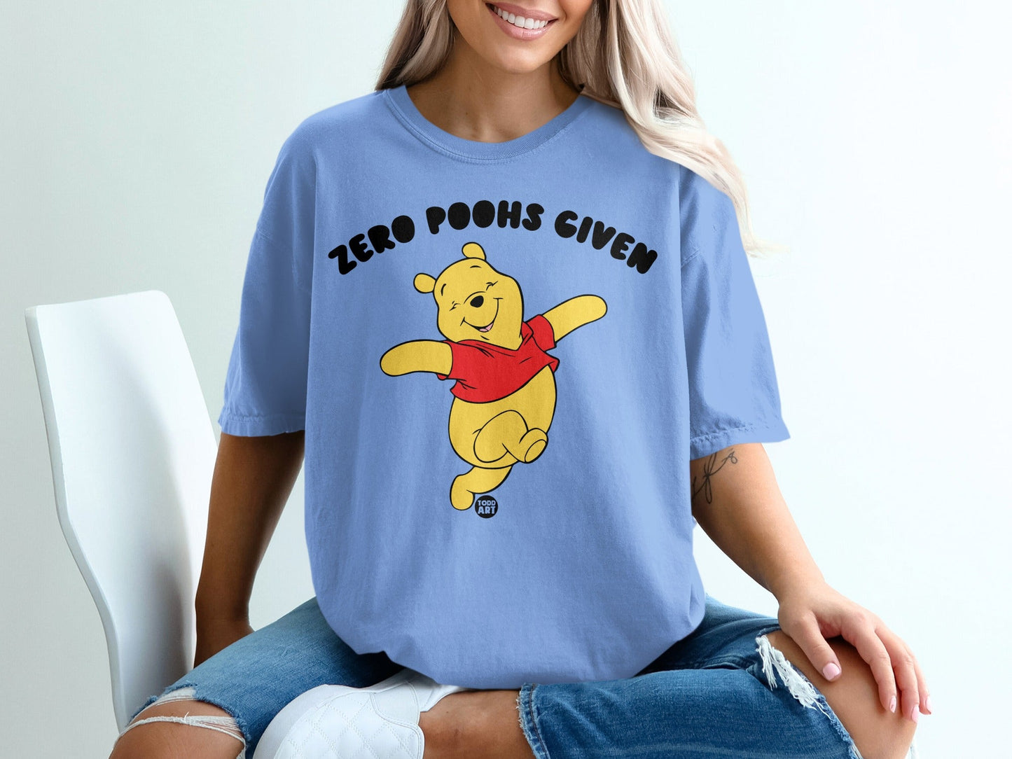 Light blue t-shirt with Winnie the Pooh graphic and text "ZERO POOHS GIVEN".
