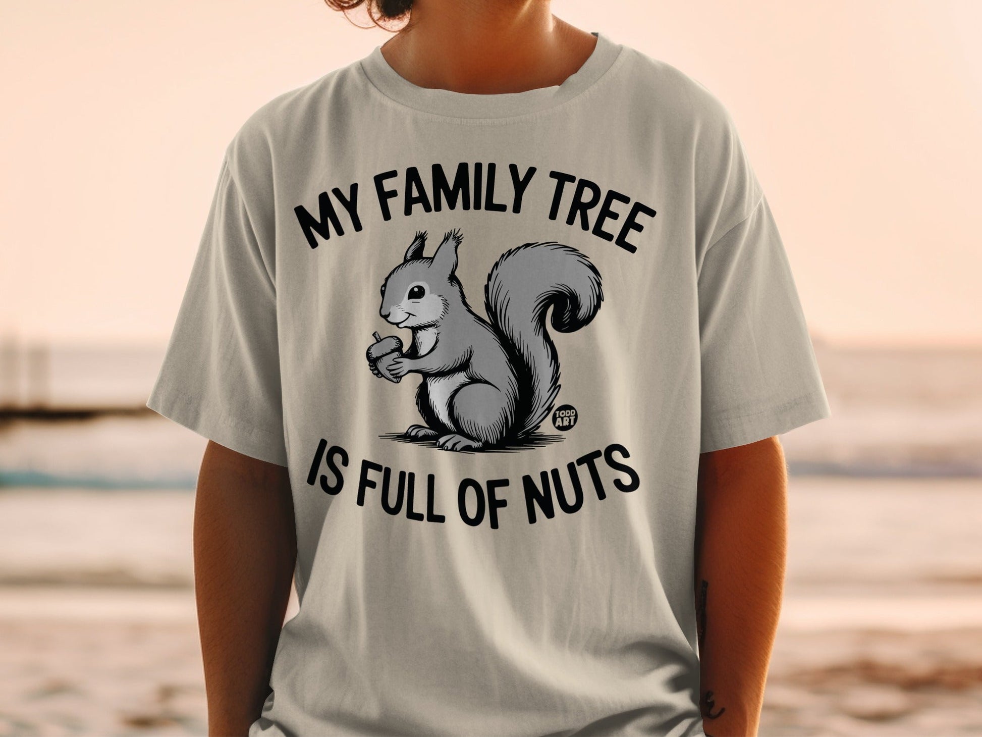 T-shirt with a squirrel holding an acorn and text "MY FAMILY TREE IS FULL OF NUTS".