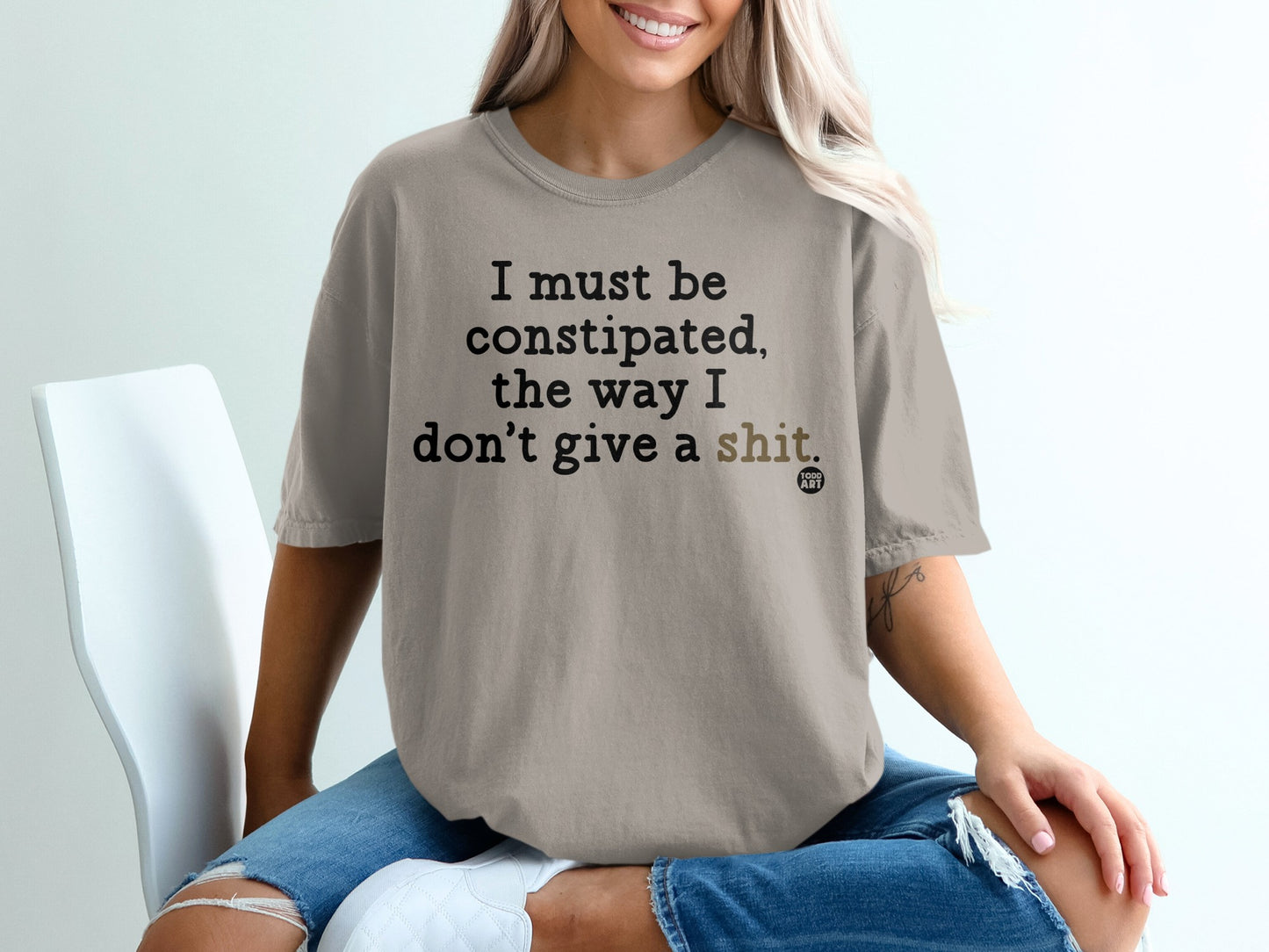 Tan t-shirt with text "I must be constipated, the way I don't give a shit."