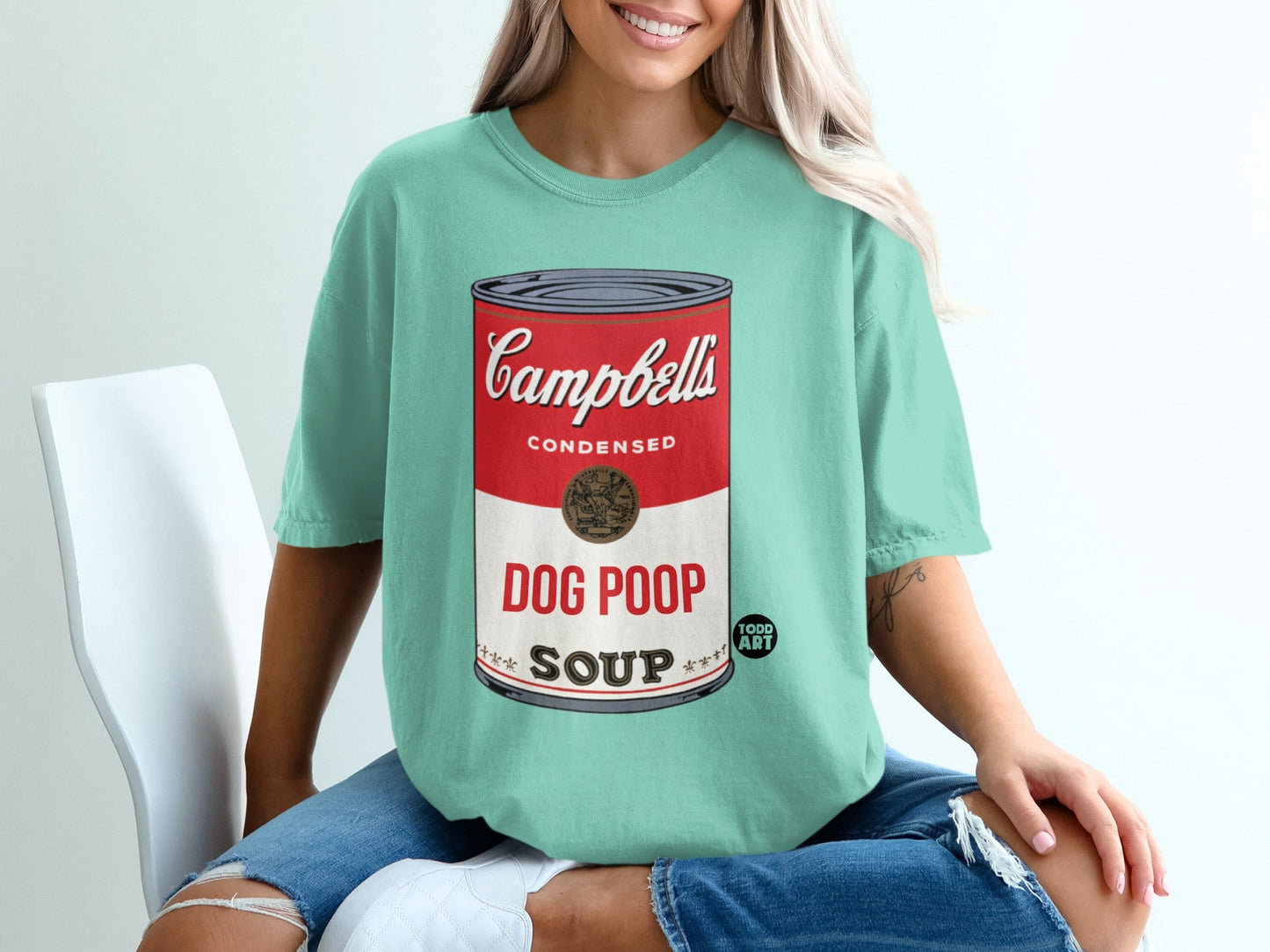 Campbell's Dog Poop Soup condensed soup can design on a teal t-shirt.