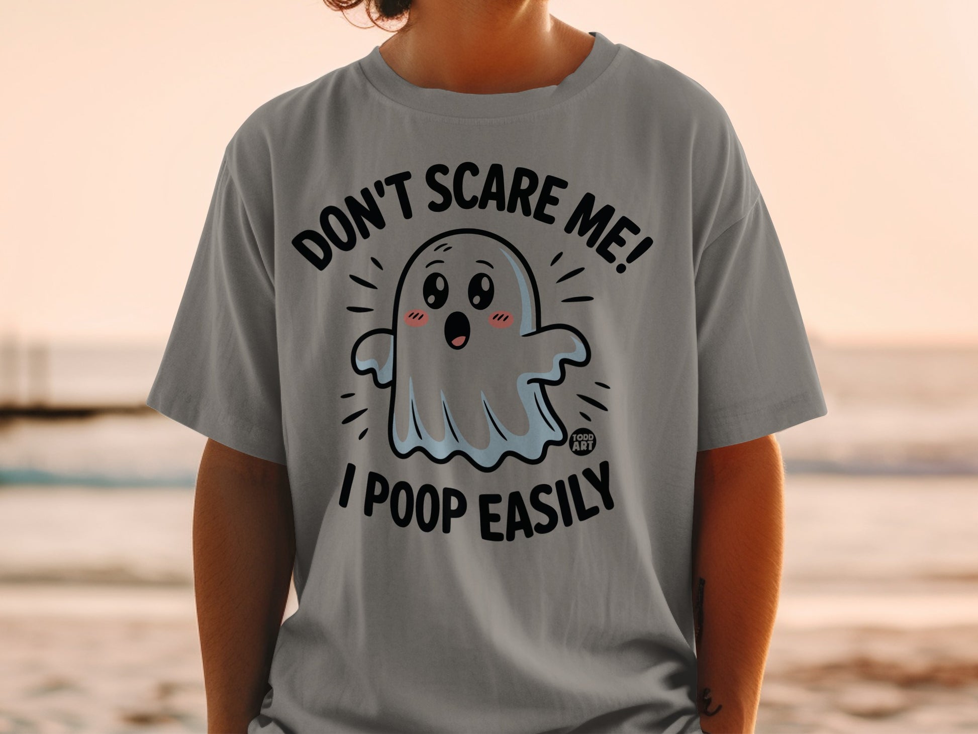 Gray t-shirt with ghost graphic saying "Don't scare me! I poop easily."