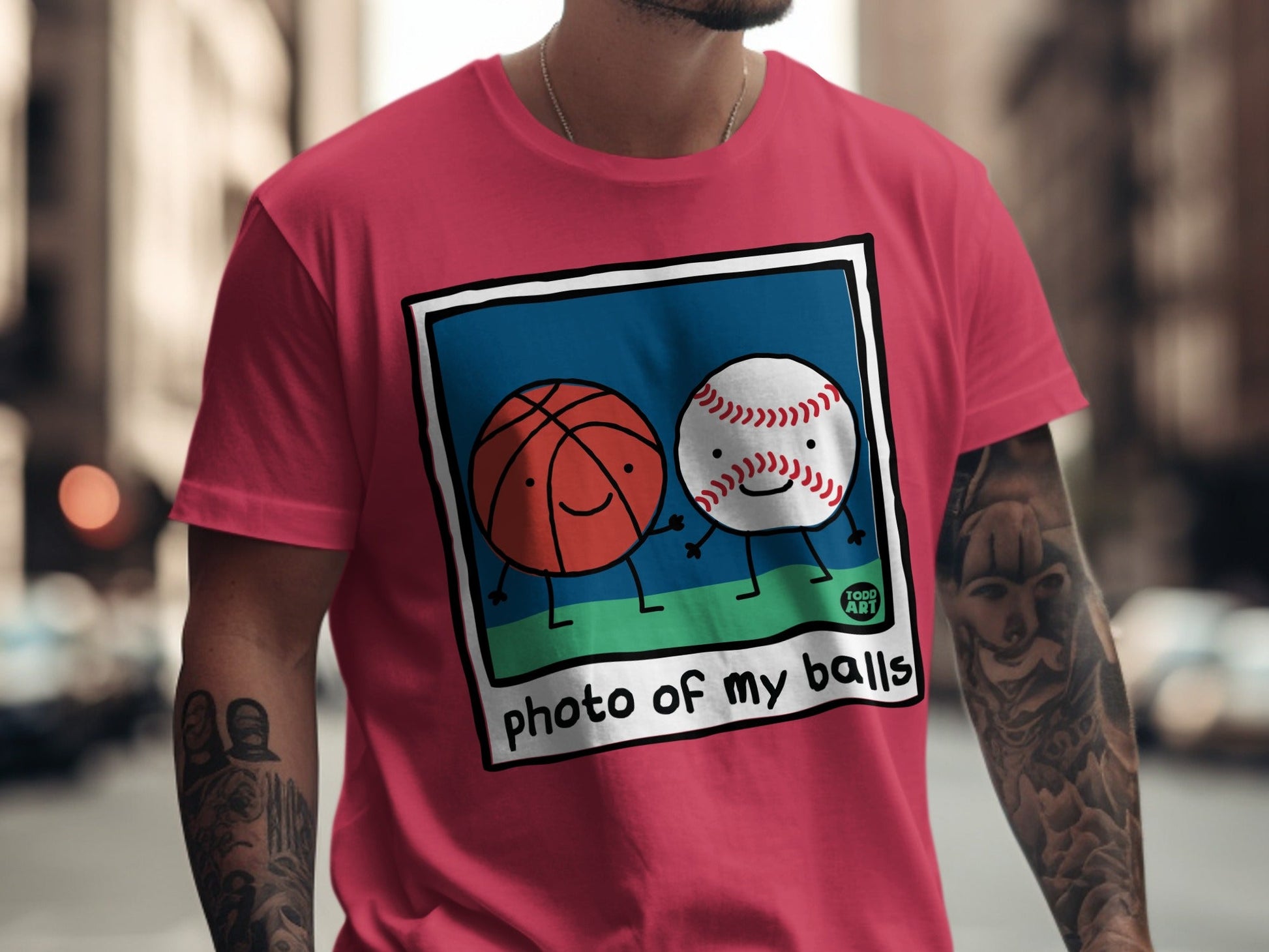 Pink t-shirt with cartoon basketball and baseball smiling, text "photo of my balls".