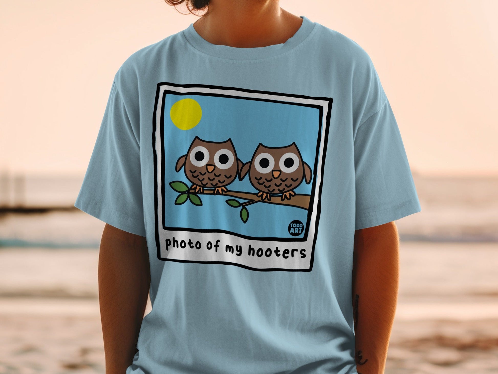 Two cartoon owls sitting on a branch with "photo of my hooters" text.