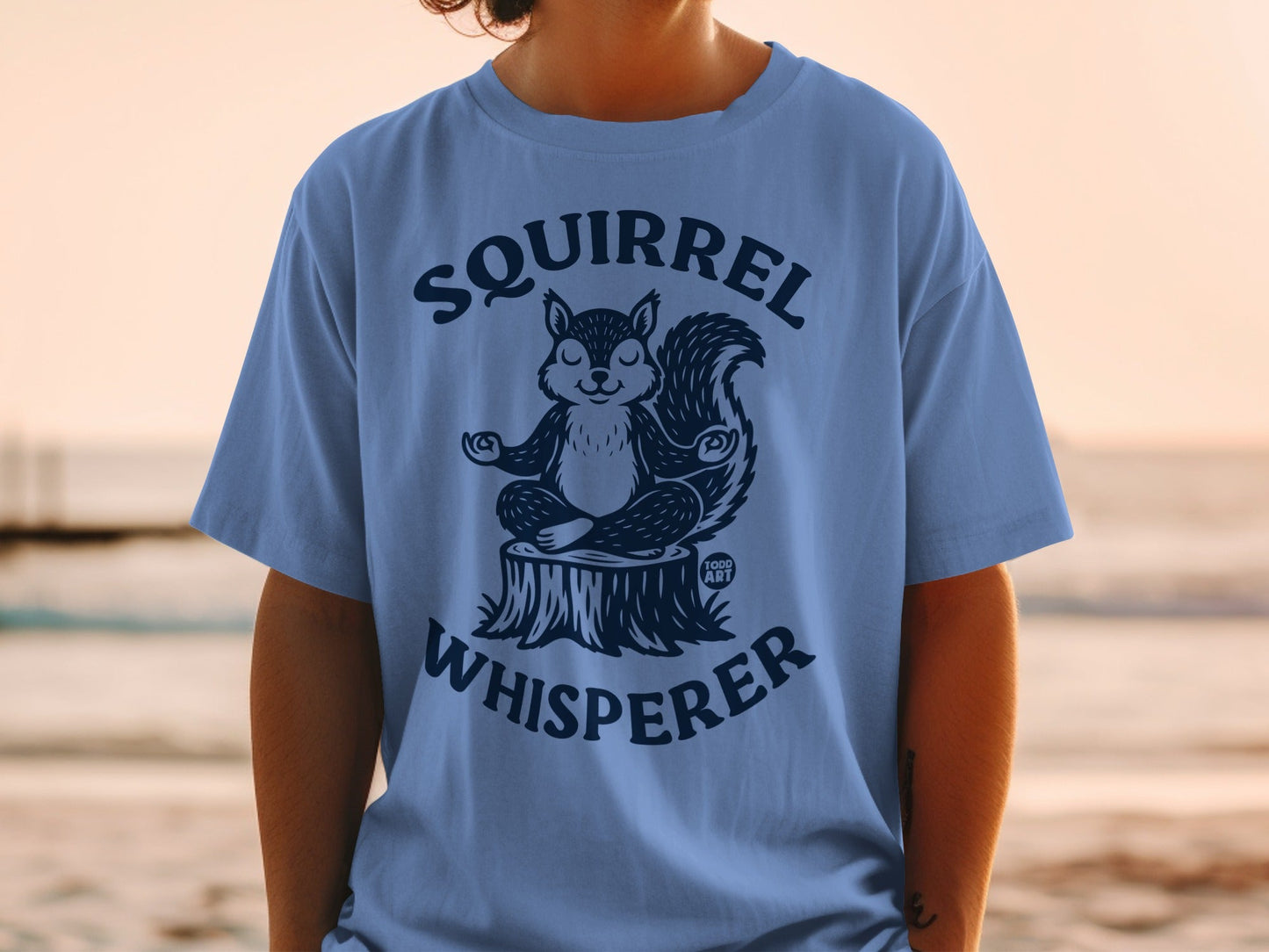 T-shirt with meditating squirrel graphic and "Squirrel Whisperer" text.