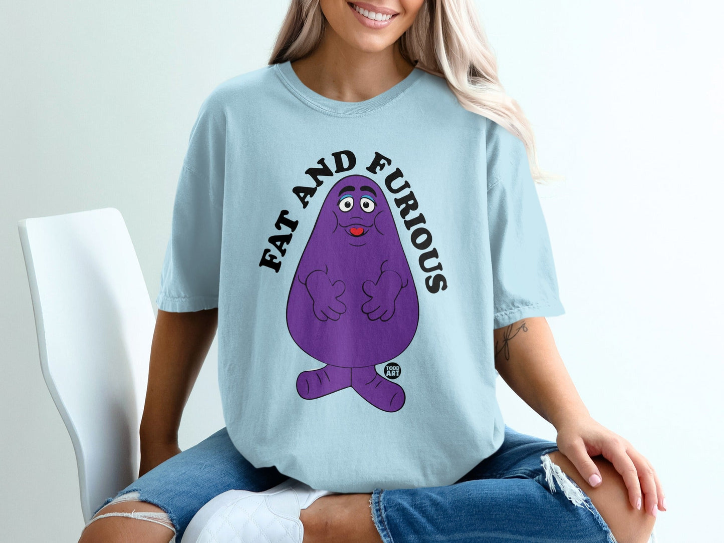 Grimace character with "FAT AND FURIOUS" text on a light blue t-shirt.