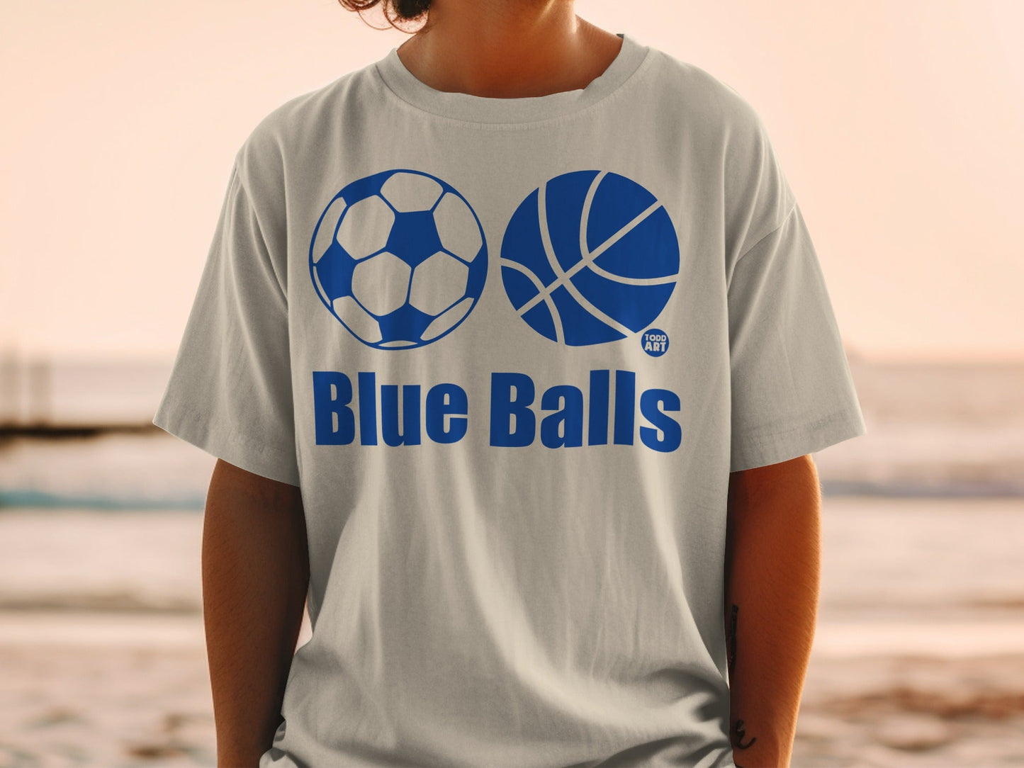 Gray t-shirt with "Blue Balls" text and soccer and basketball graphics.