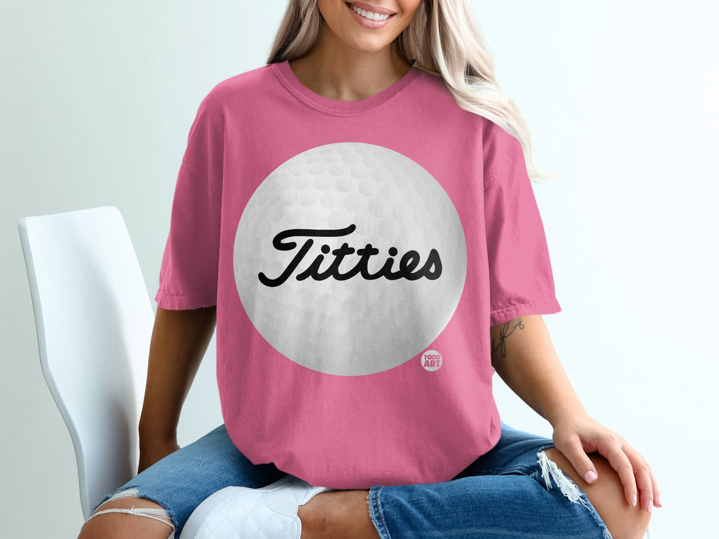 Pink t-shirt with "Titties" and a golf ball graphic.