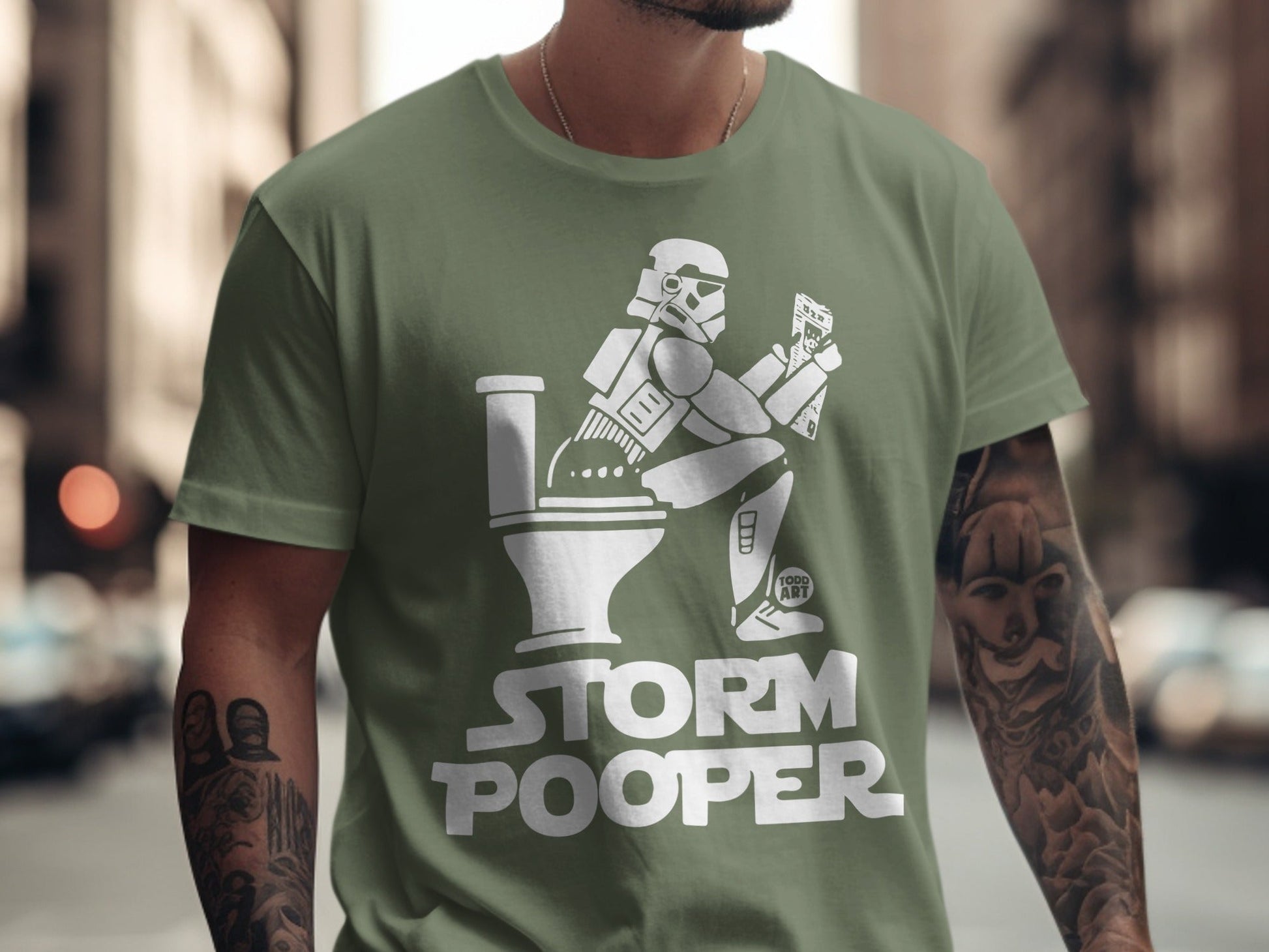 Green t-shirt with a Stormtrooper on a toilet, reading.