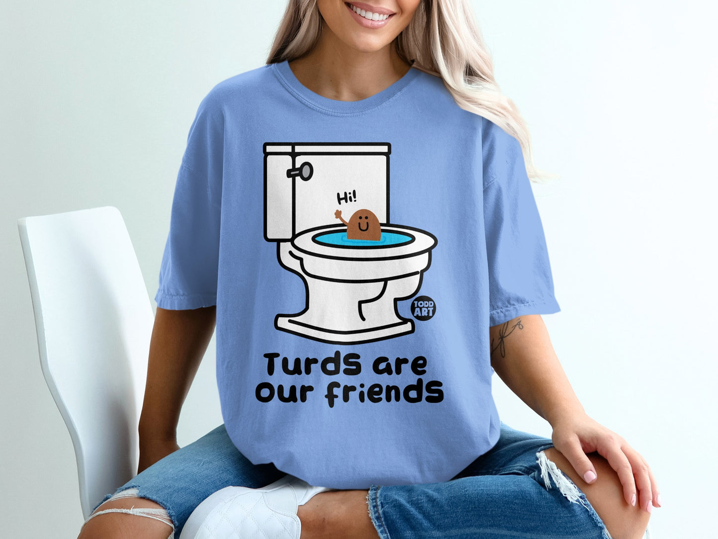 Blue t-shirt with cartoon toilet and smiling poop character, text "Turds are our friends".