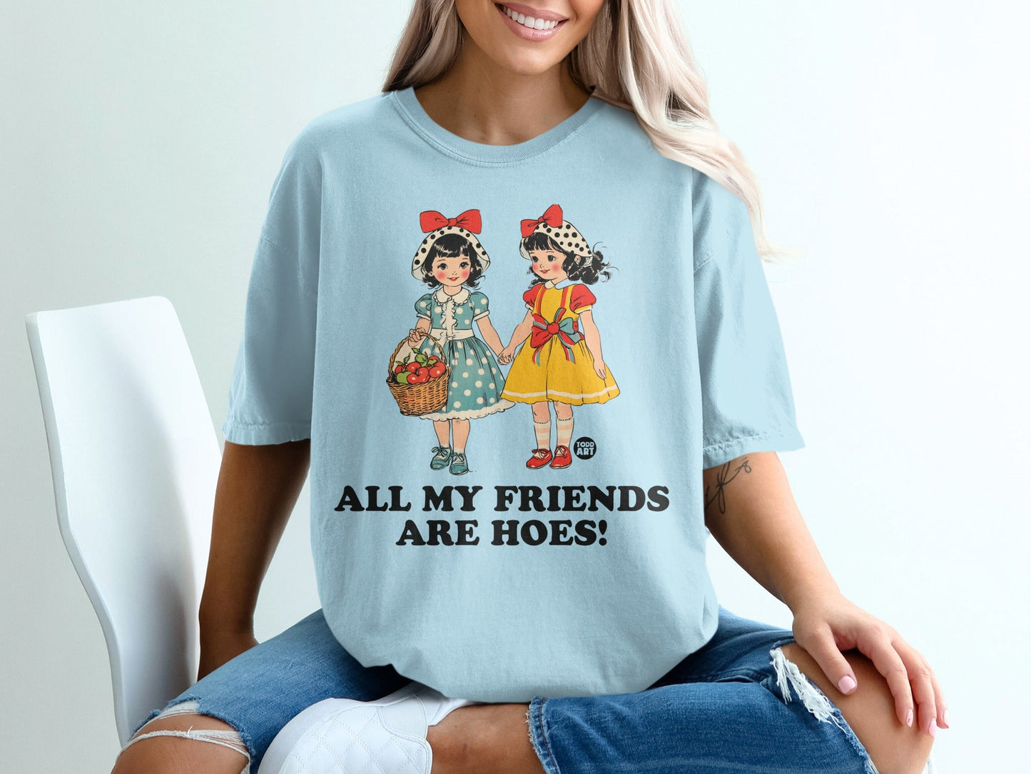 Light blue t-shirt with graphic of two girls and "ALL MY FRIENDS ARE HOES!" text.