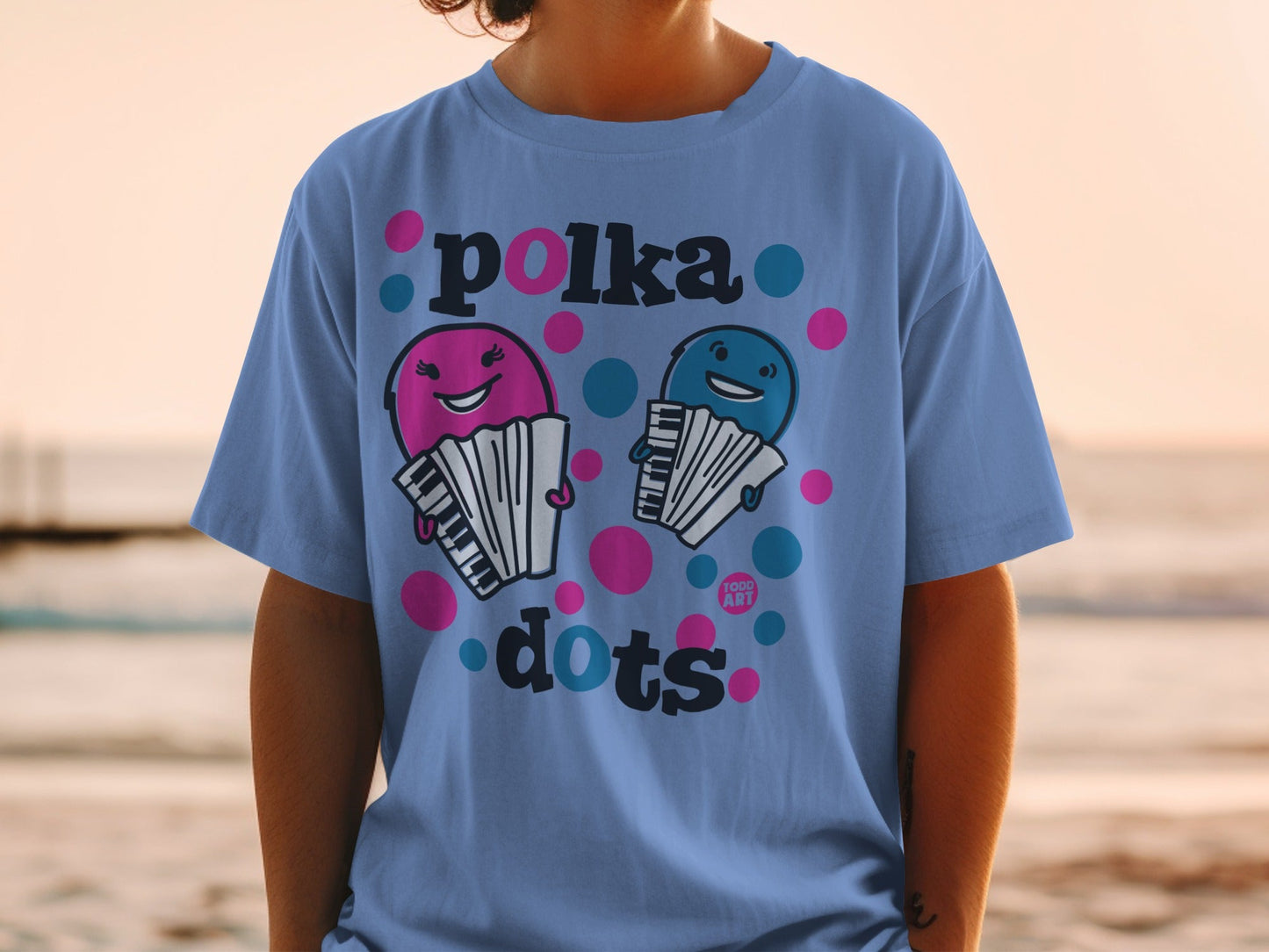 Blue t-shirt with cartoon accordions playing under "polka dots" text.