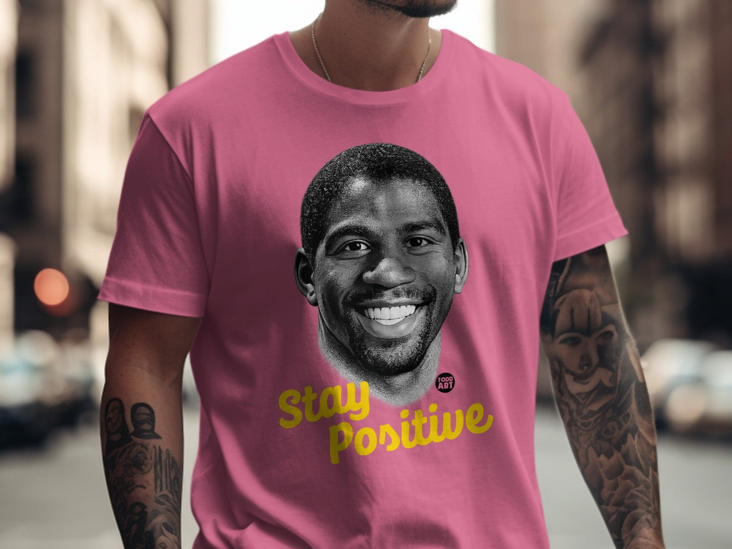 Pink t-shirt with Magic Johnson's portrait and "Stay Positive" text.