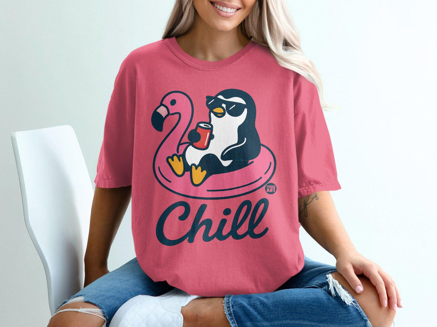 Penguin in sunglasses on flamingo float with "Chill" text on pink t-shirt.