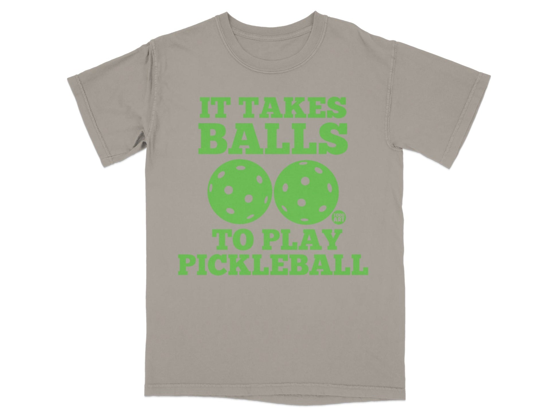 T-shirt with green text and pickleball graphics: "IT TAKES BALLS TO PLAY PICKLEBALL".