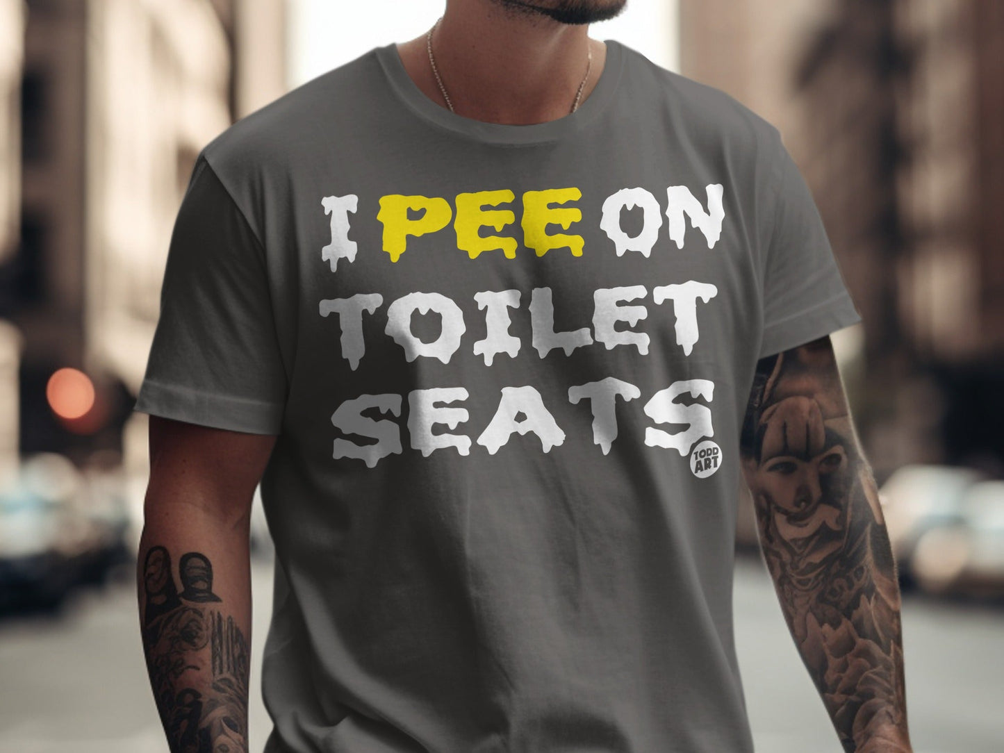 Gray t-shirt with "I PEE ON TOILET SEATS" text in yellow and white.