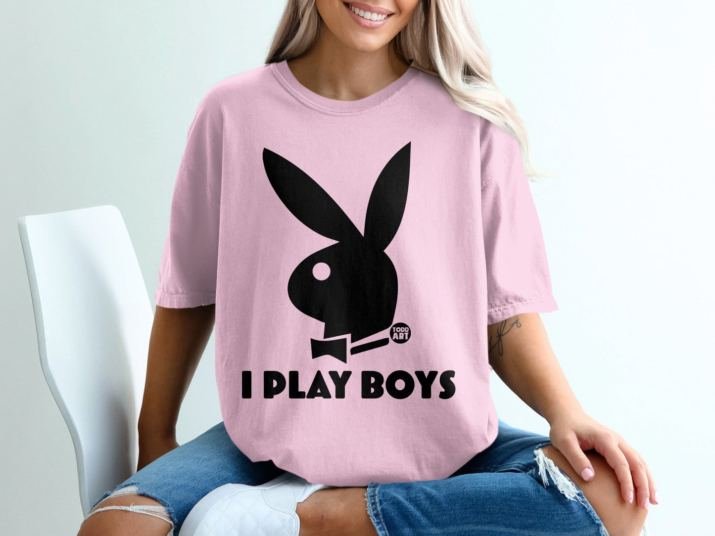 Pink t-shirt with black Playboy bunny logo and "I PLAY BOYS" text.
