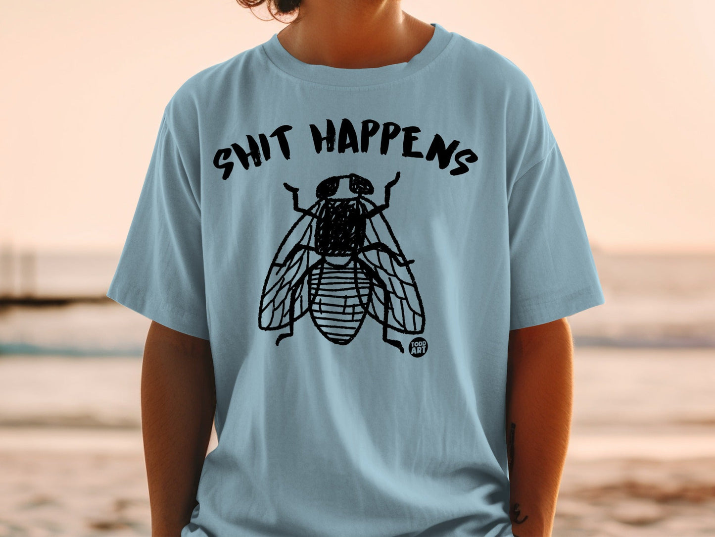 Shit Happens Fly Graphic Design on Light Blue Shirt