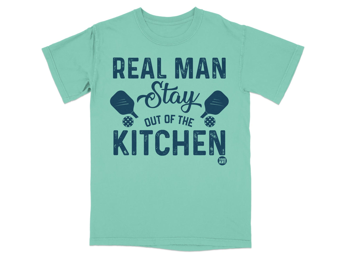 Teal t-shirt with "Real Man Stay Out of the Kitchen" and pickleball paddles.
