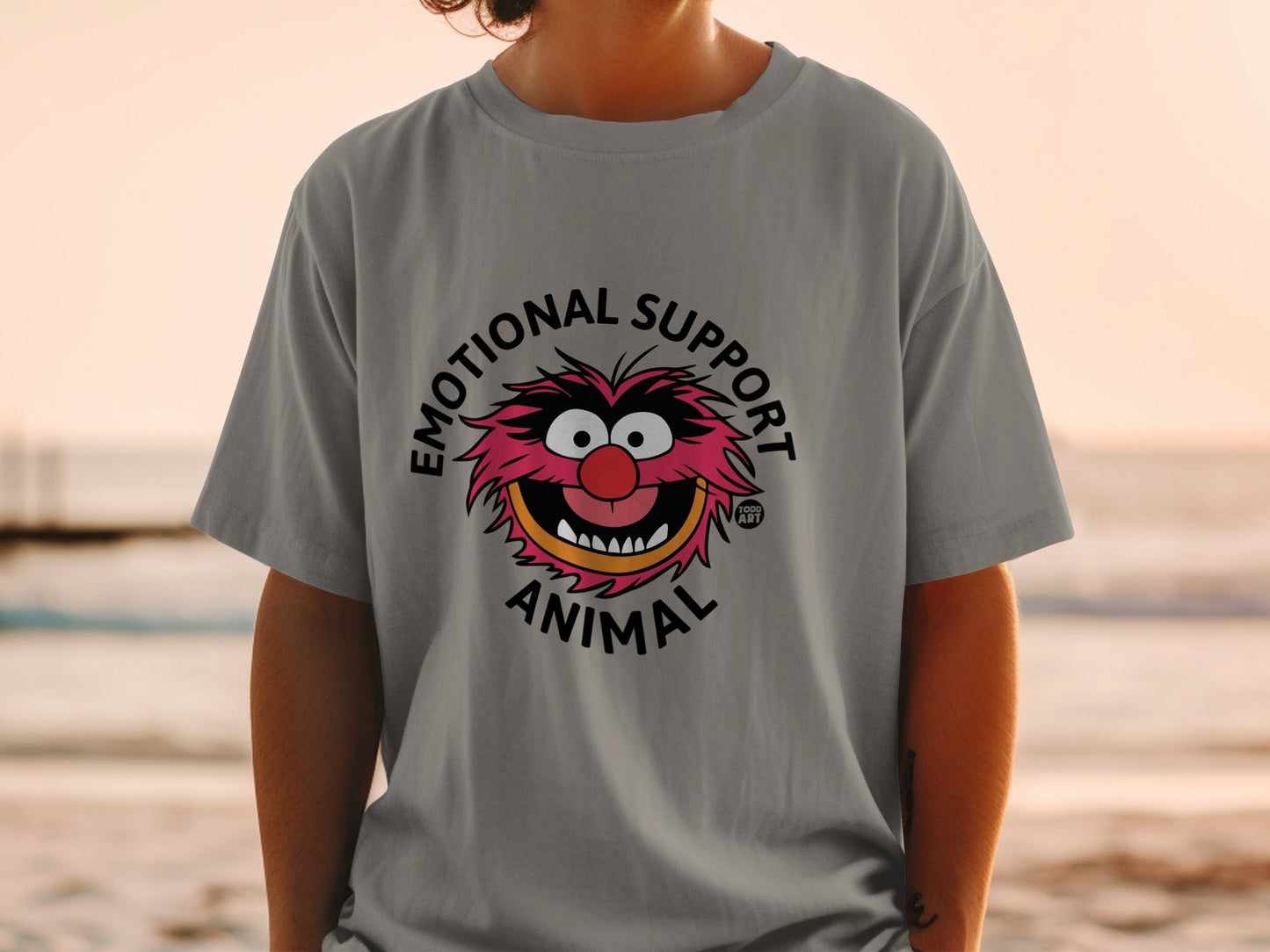 Grey t-shirt with "Emotional Support Animal" text and Muppet Animal face graphic.