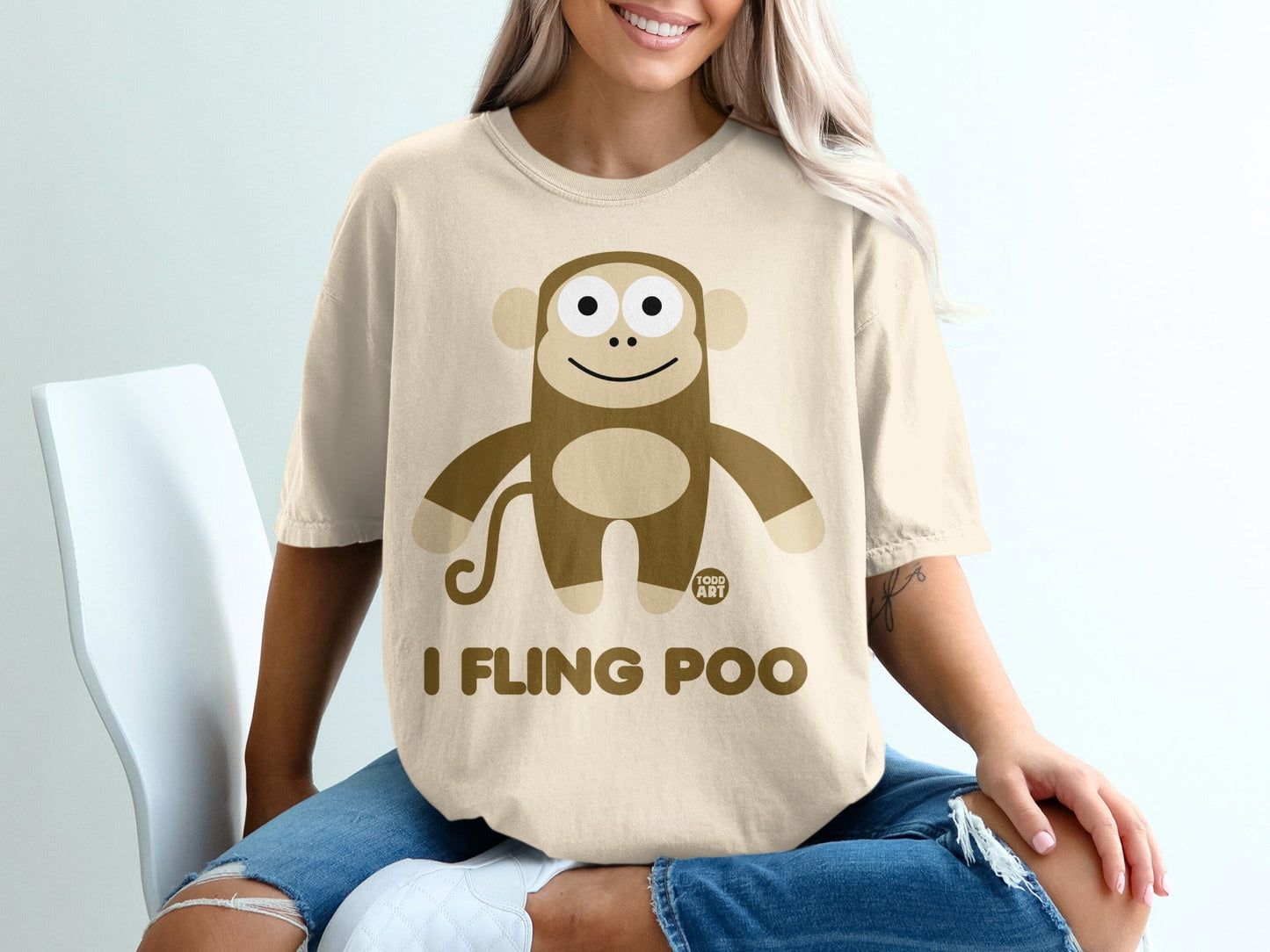 Beige t-shirt with cartoon monkey and text "I FLING POO".