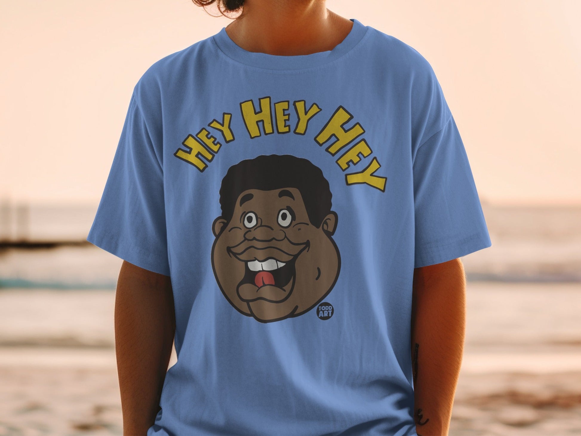 Blue t-shirt with cartoon face and "HEY HEY HEY" text.