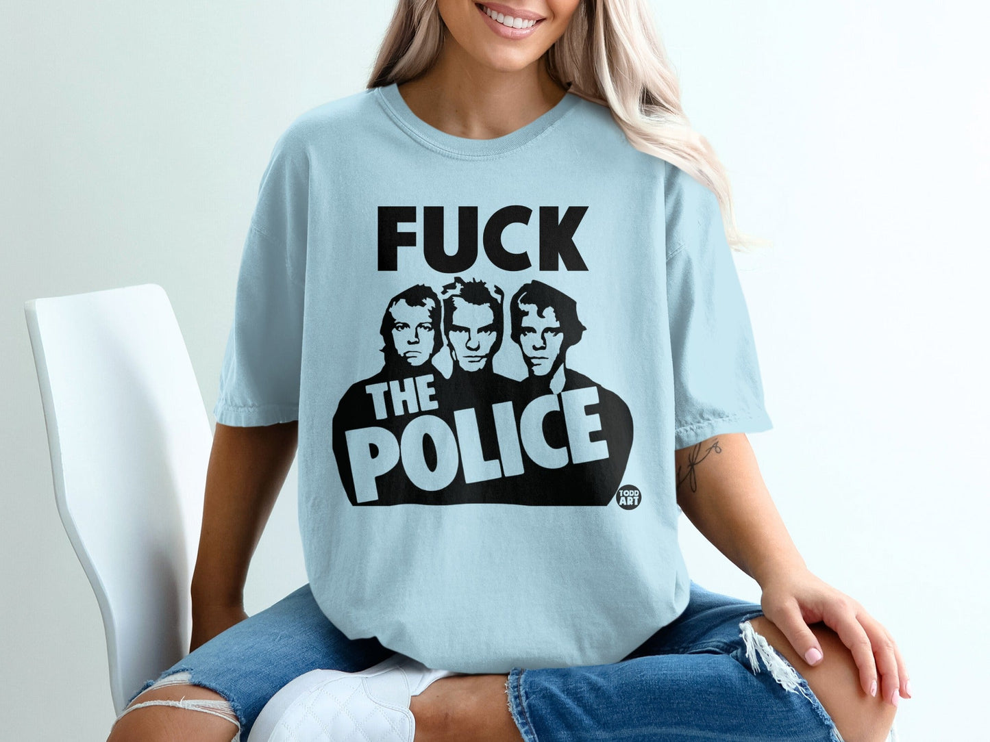 Light blue t-shirt with black "FUCK THE POLICE" text and band members.