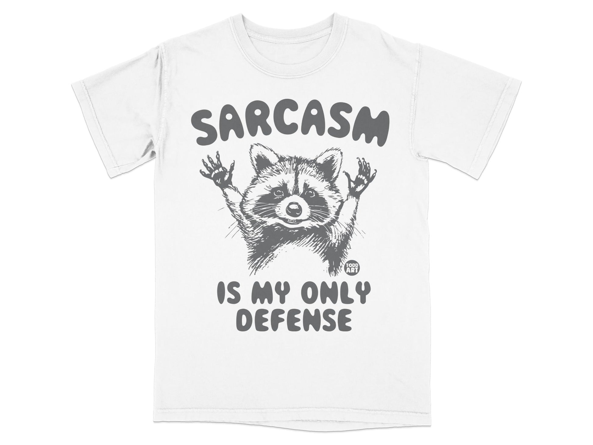 T-shirt with raccoon graphic and "Sarcasm Is My Only Defense" text.