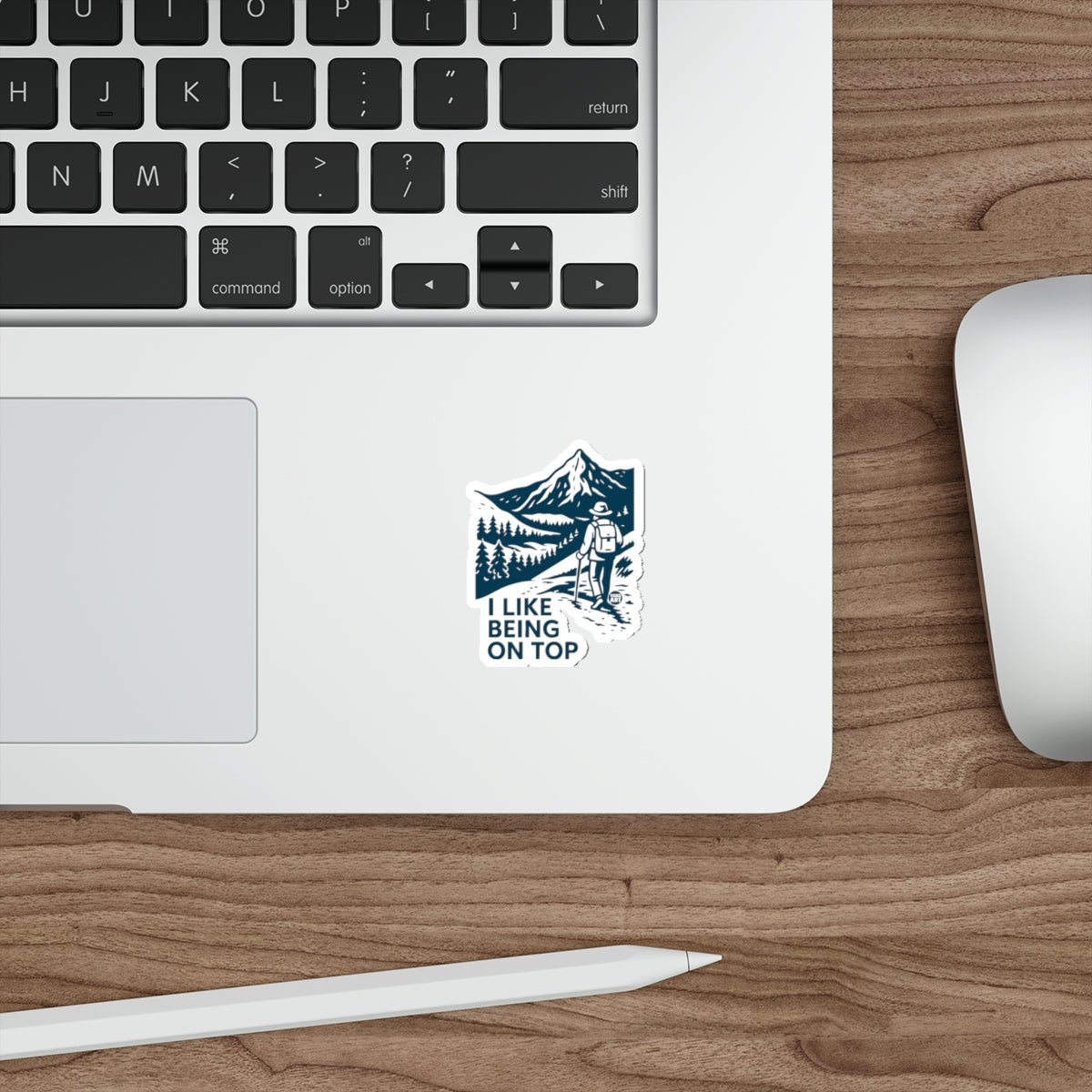Sticker with hiker and mountains, reads "I LIKE BEING ON TOP".
