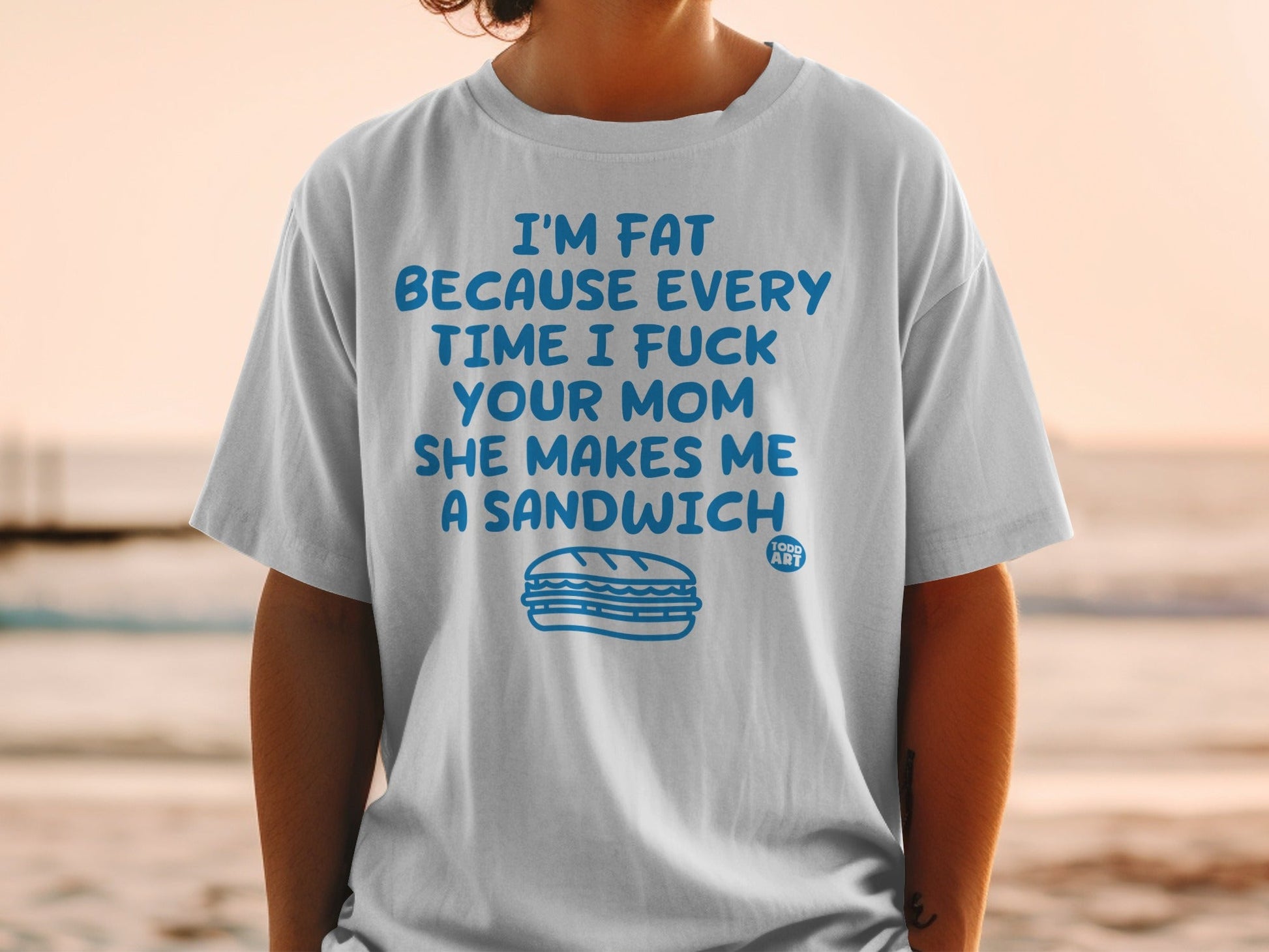 White t-shirt with "I'm fat because every time I fuck your mom she makes me a sandwich" and sandwich graphic.