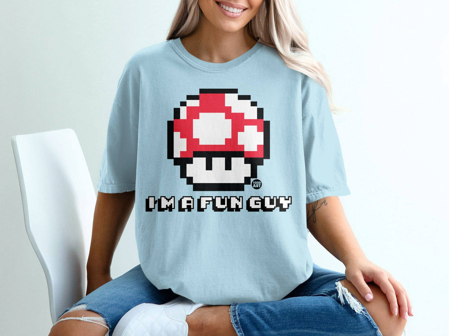 Light blue t-shirt with a pixelated Super Mario mushroom and "I'M A FUN GUY" text.