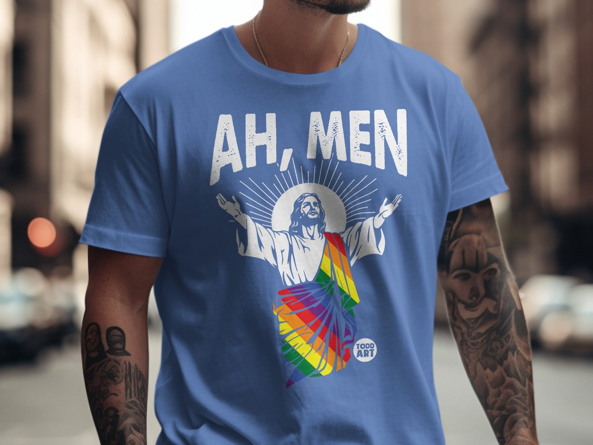 Jesus in rainbow colors on a blue t-shirt that says "AH, MEN".
