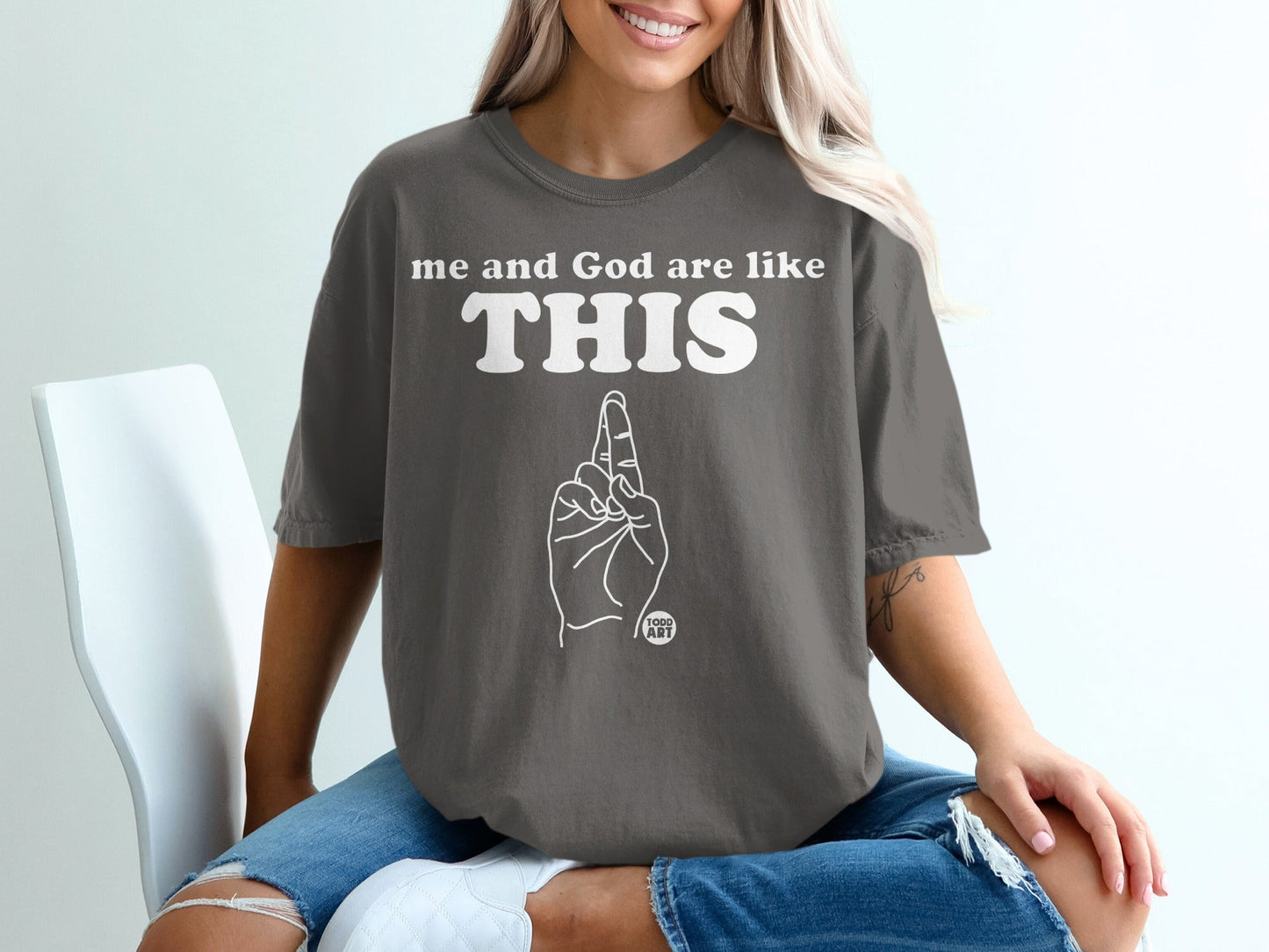 Gray t-shirt with "me and God are like THIS" and finger pointing up.