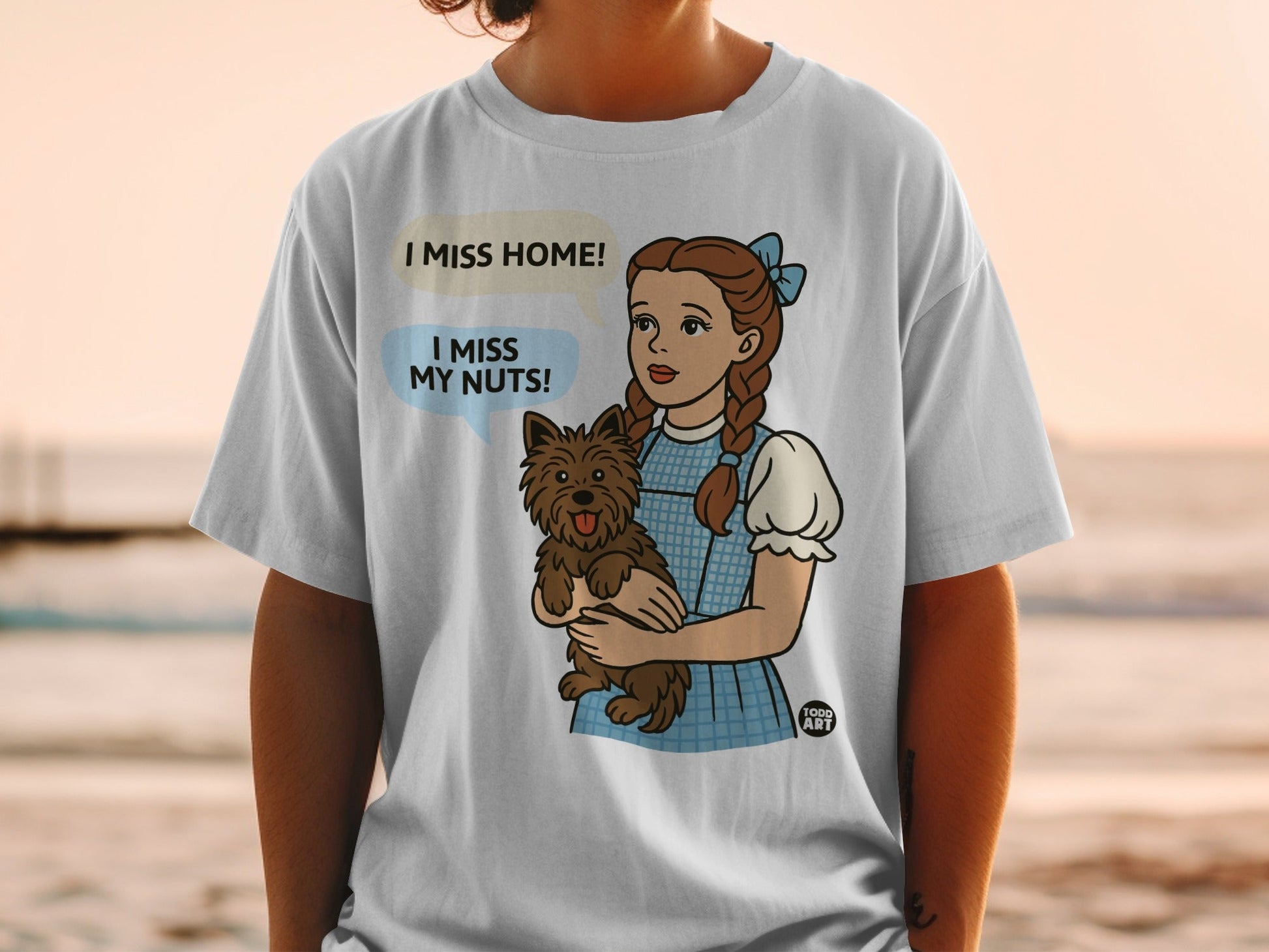 Dorothy holding Toto, text reads "I miss home! I miss my nuts!"