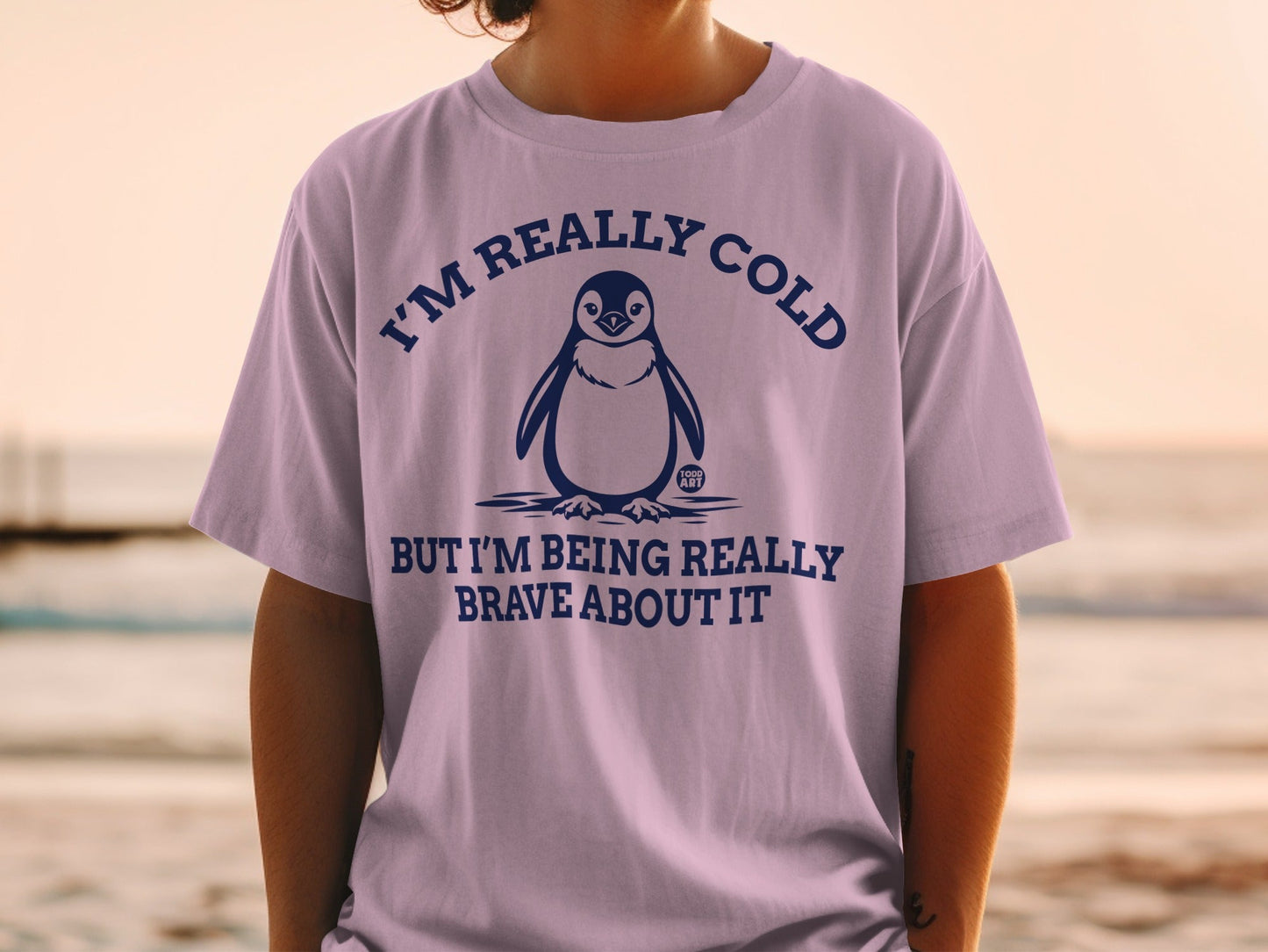T-shirt with penguin illustration and text "I'M REALLY COLD BUT I'M BEING REALLY BRAVE ABOUT IT".