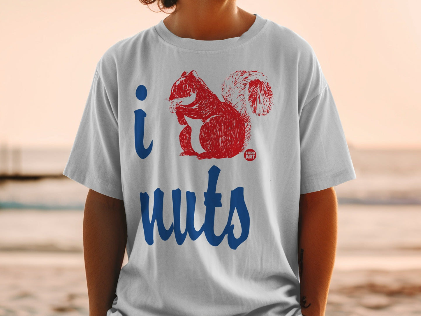 White t-shirt with "I" and a red squirrel design, plus "nuts" text.