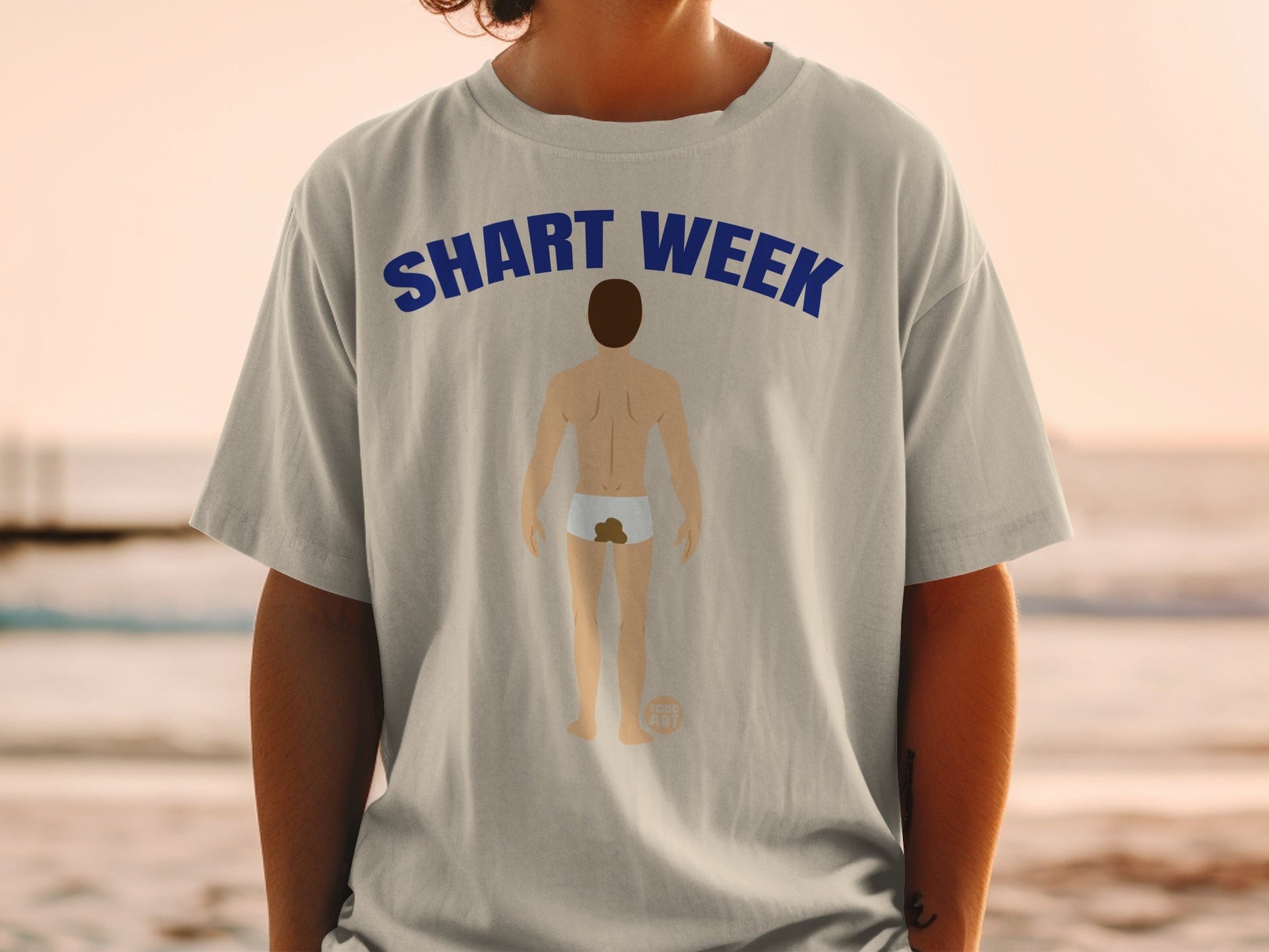 T-shirt with "SHART WEEK" text and cartoon of person with poop stain.
