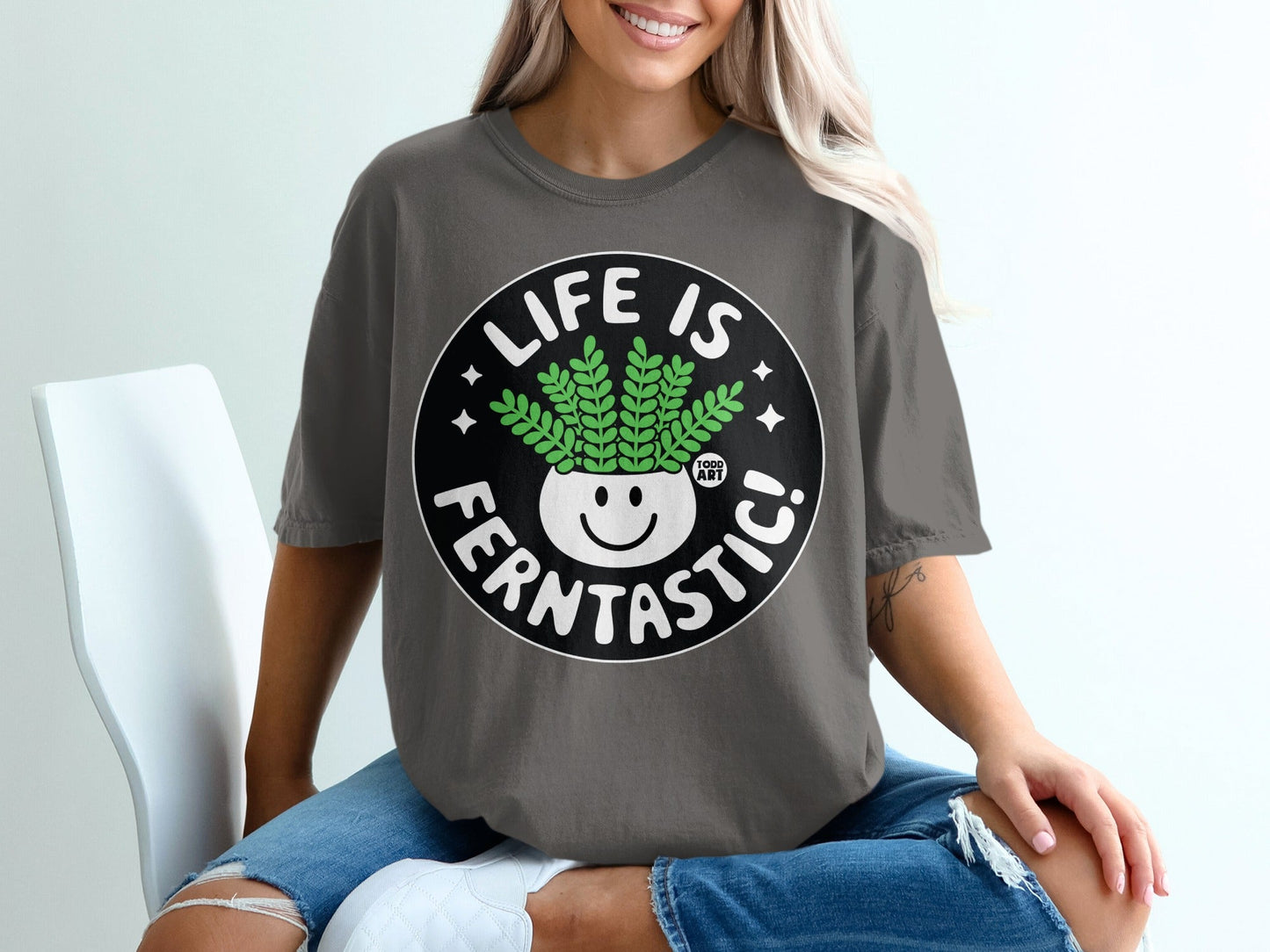 Dark gray t-shirt with white text and a smiling plant pot graphic.
