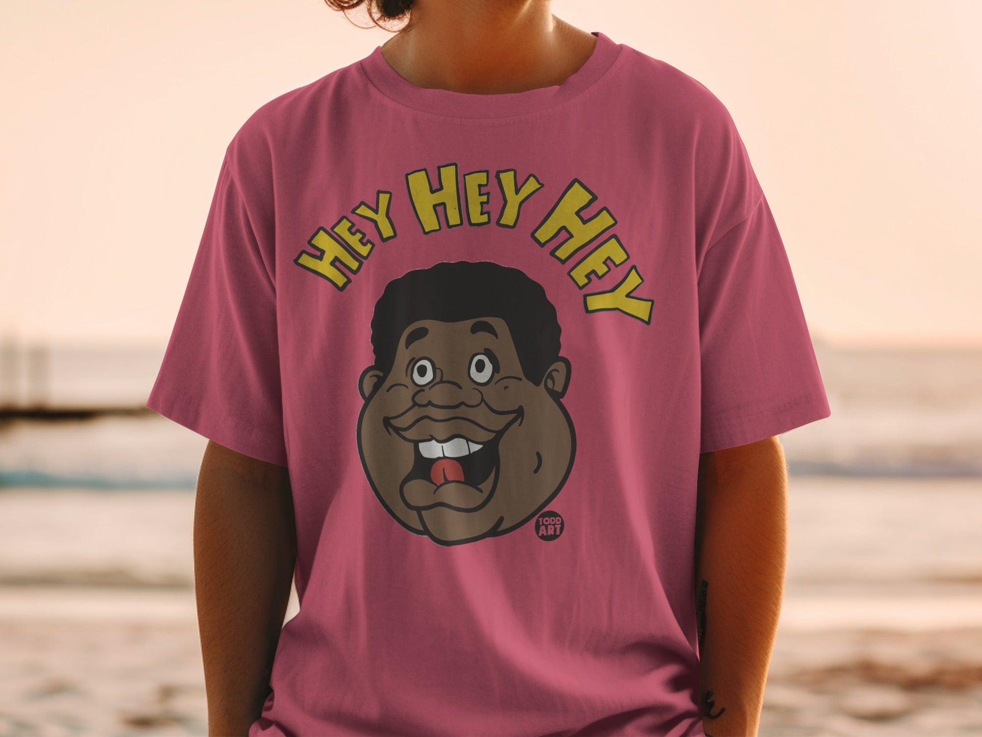 Pink t-shirt with cartoon face and "HEY HEY HEY" text.