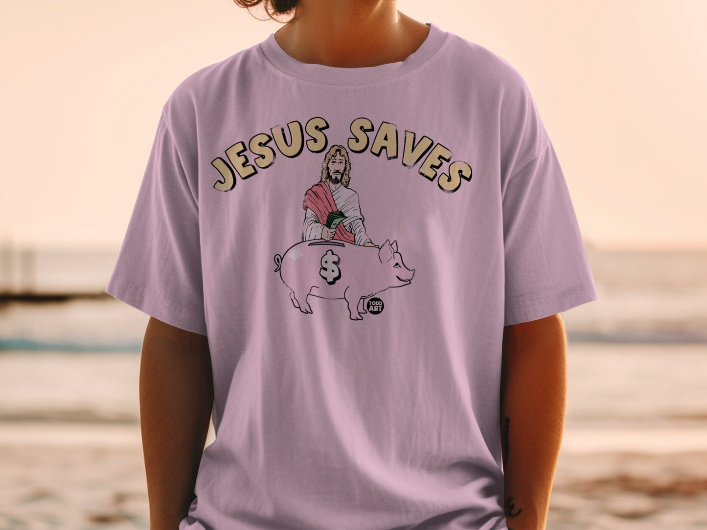 T-shirt with "JESUS SAVES" and Jesus piggybacking a pig.
