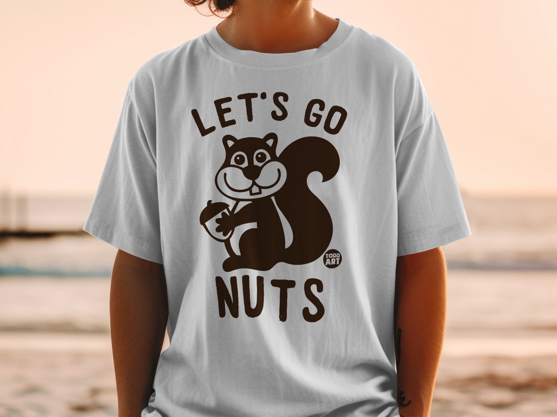 T-shirt with "Let's Go Nuts" and a squirrel holding an acorn.