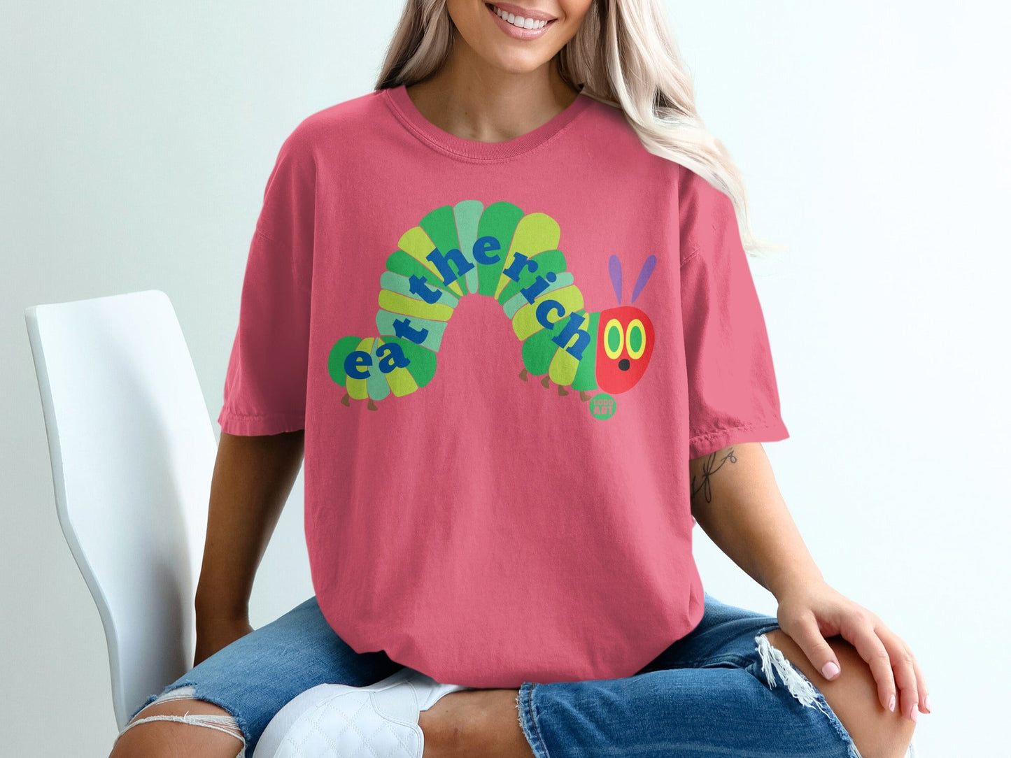 Pink t-shirt with cartoon caterpillar that says "eat the rich"