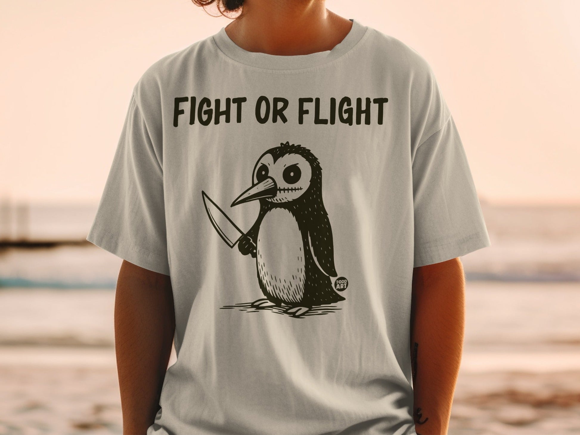 Penguin wearing a t-shirt with "Fight or Flight" and a knife.
