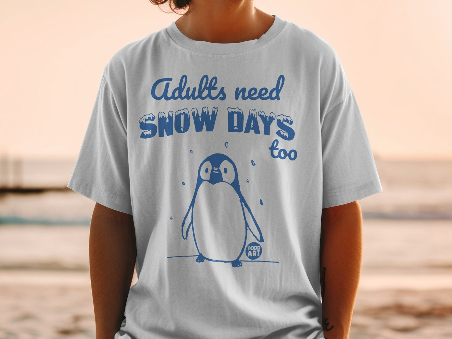 T-shirt with blue penguin graphic and "Adults need Snow Days too" text.