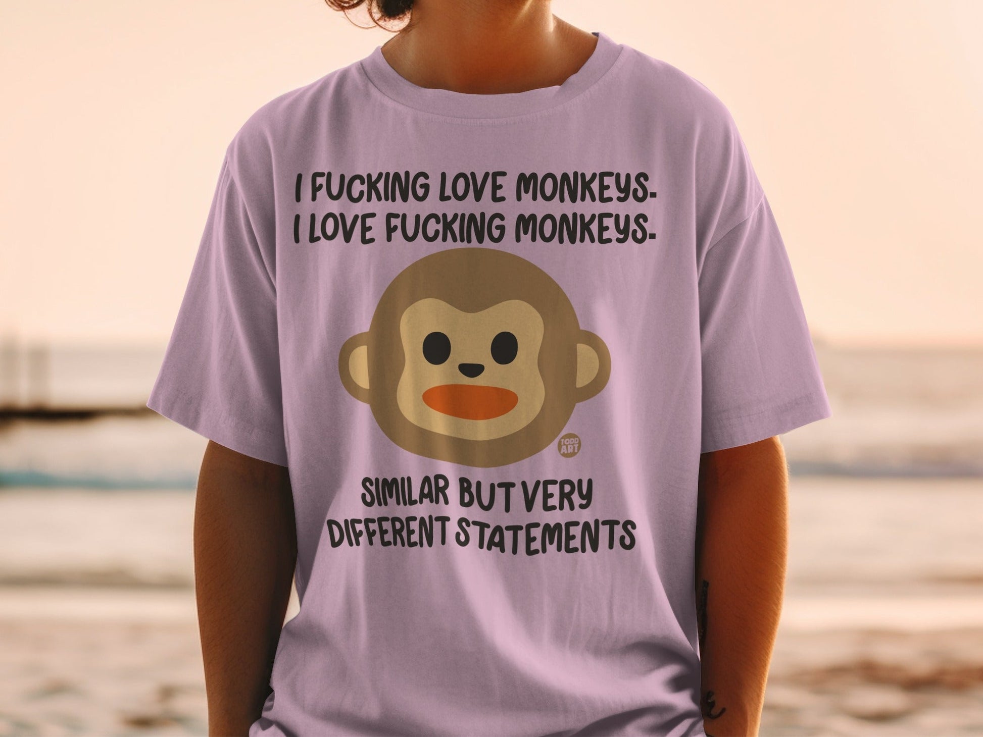 Purple t-shirt with monkey face and contrasting text about monkeys.