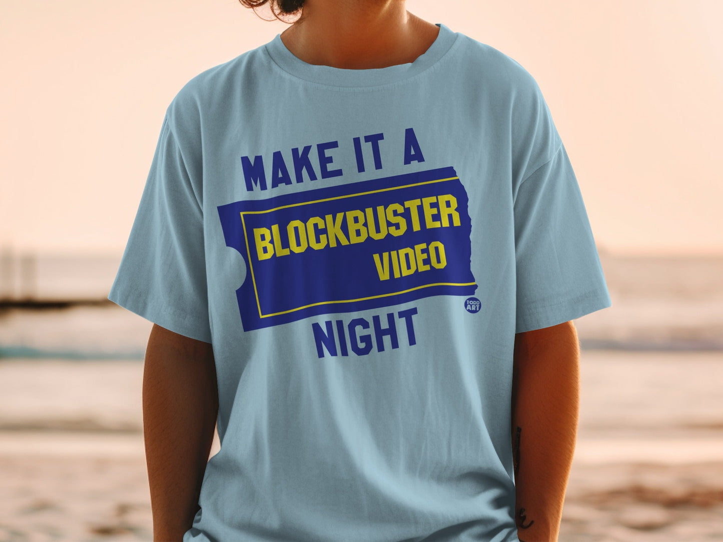 Light blue t-shirt with "Make it a Blockbuster Night" in yellow and blue.