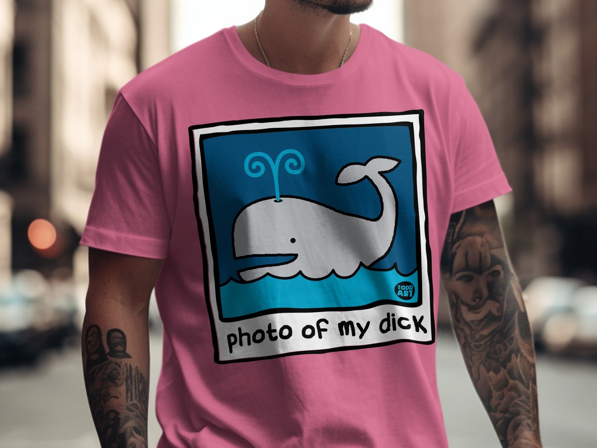 Pink t-shirt with cartoon whale illustration and "photo of my dick" text.