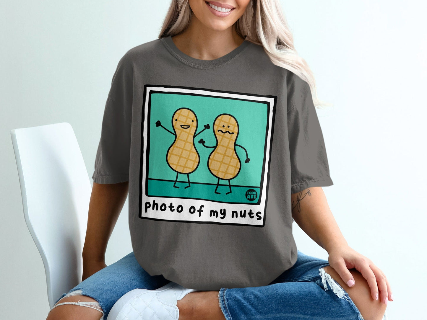 Dark gray t-shirt with cartoon peanuts saying "photo of my nuts".