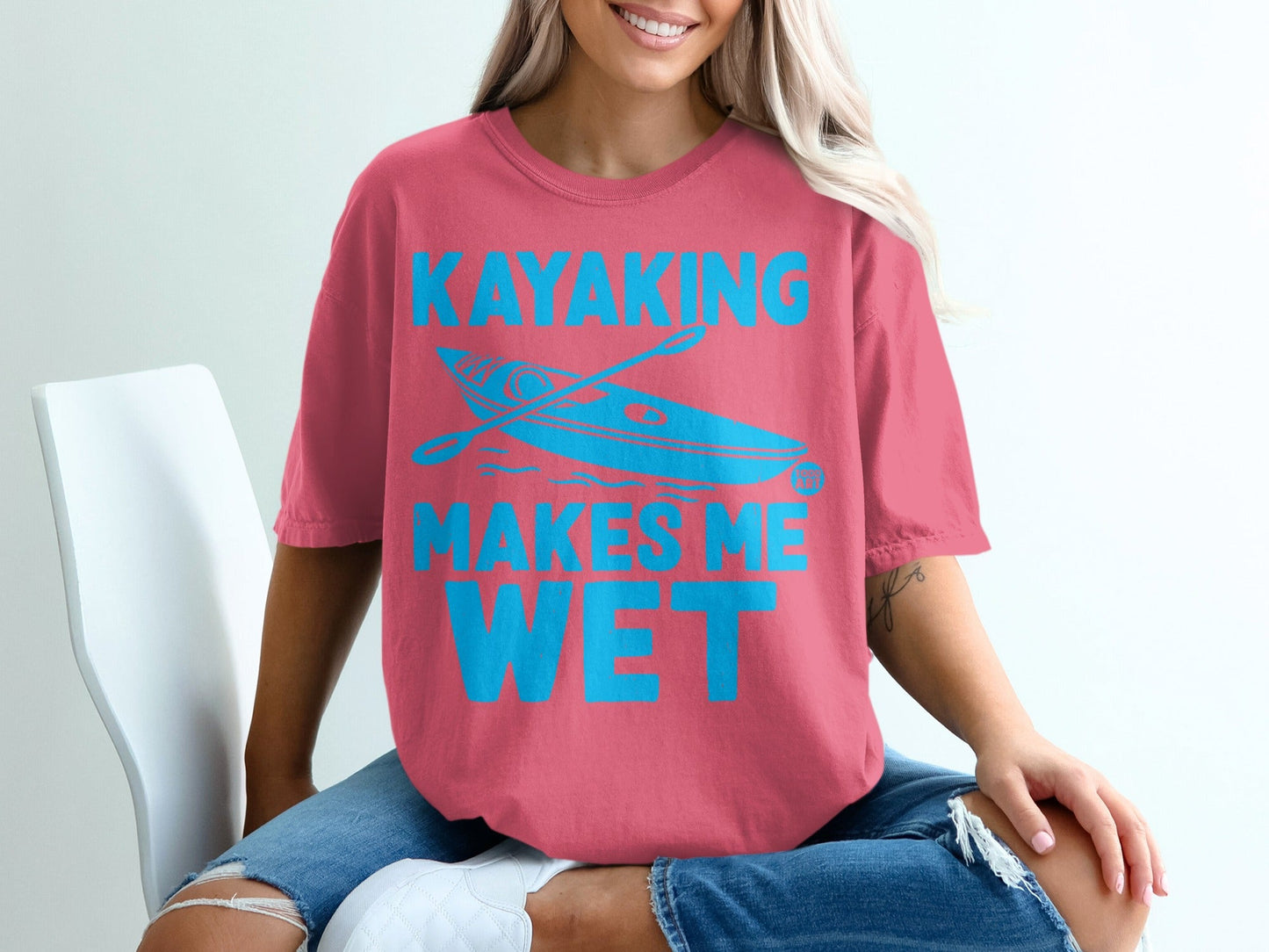 Pink t-shirt with "Kayaking Makes Me Wet" and kayak graphic.